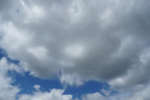 White fluffy clouds in the sky. Blue sky and cloud cover on a sunny summer da 写真素材