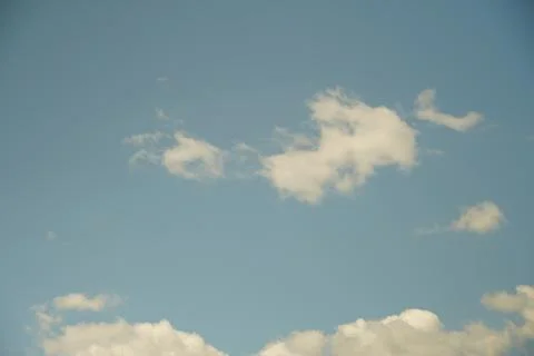 White fluffy clouds in the sky. Blue sky and cloud cover on a sunny summer da 写真素材