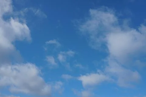 White fluffy clouds in the sky. Blue sky and cloud cover on a sunny summer da 写真素材