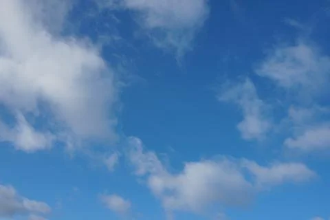 White fluffy clouds in the sky. Blue sky and cloud cover on a sunny summer da 写真素材