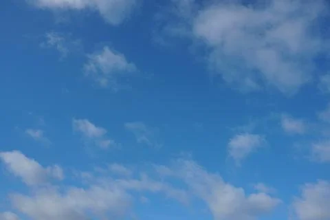 White fluffy clouds in the sky. Blue sky and cloud cover on a sunny summer da 写真素材