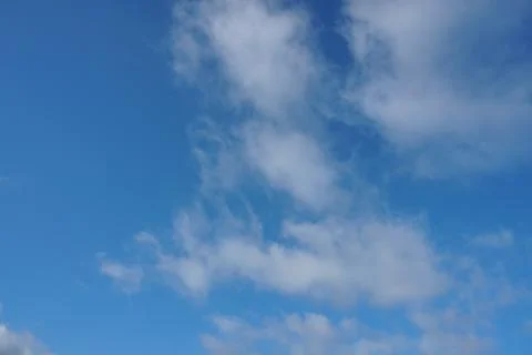 White fluffy clouds in the sky. Blue sky and cloud cover on a sunny summer da 写真素材