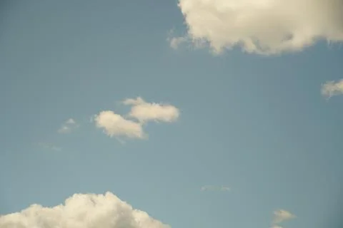 White fluffy clouds in the sky. Blue sky and cloud cover on a sunny summer da 写真素材