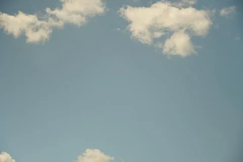 White fluffy clouds in the sky. Blue sky and cloud cover on a sunny summer da Stock Photos