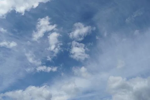 White fluffy clouds in the sky. Blue sky and cloud cover on a sunny summer da 写真素材