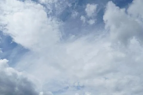 White fluffy clouds in the sky. Blue sky and cloud cover on a sunny summer da 写真素材