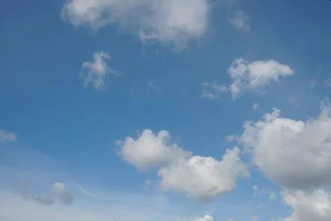 White fluffy clouds in the sky. Blue sky and cloud cover on a sunny summer da 写真素材
