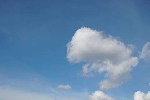 White fluffy clouds in the sky. Blue sky and cloud cover on a sunny summer da 写真素材