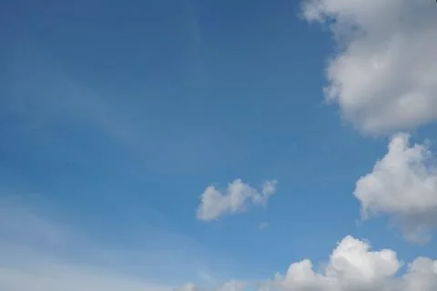 White fluffy clouds in the sky. Blue sky and cloud cover on a sunny summer da 写真素材
