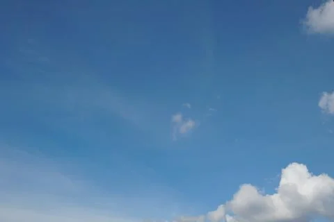 White fluffy clouds in the sky. Blue sky and cloud cover on a sunny summer da 写真素材