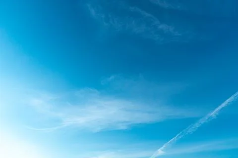 White fluffy clouds in the sky. Blue sky and cloud cover on a sunny summer da Stock Photos