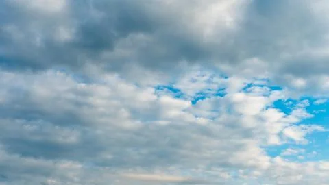 White fluffy clouds in the sky. Blue sky and cloud cover on a sunny summer da 写真素材