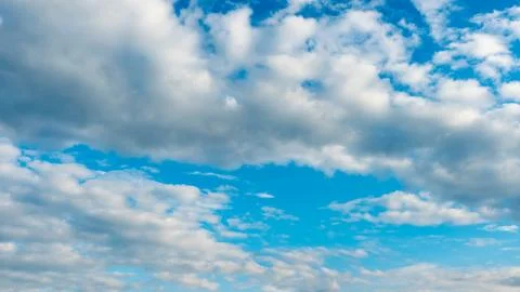 White fluffy clouds in the sky. Blue sky and cloud cover on a sunny summer da 写真素材