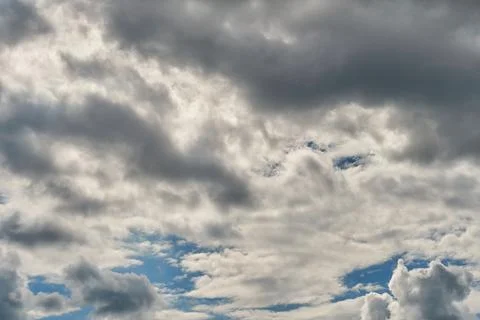 White fluffy clouds in the sky. Blue sky and cloud cover on a sunny summer da Stock Photos