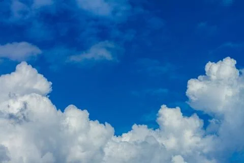 White fluffy clouds in the sky Stock Photos