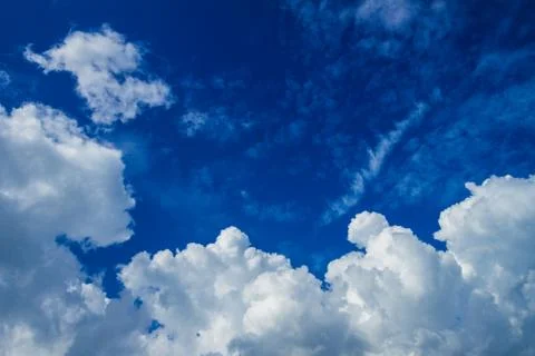 White fluffy clouds in the sky Stock Photos
