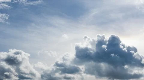 White fluffy clouds in the sky Stock Photos