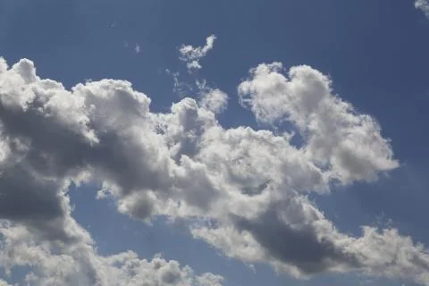 White fluffy clouds in the sky. Stock Photos