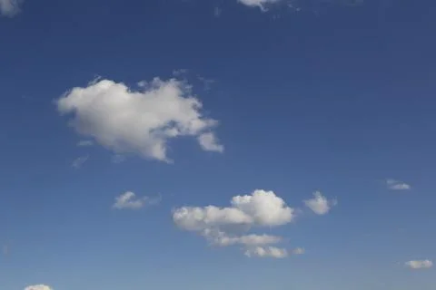 White fluffy clouds in the sky. Stock Photos