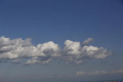 White fluffy clouds in the sky. Stock Photos