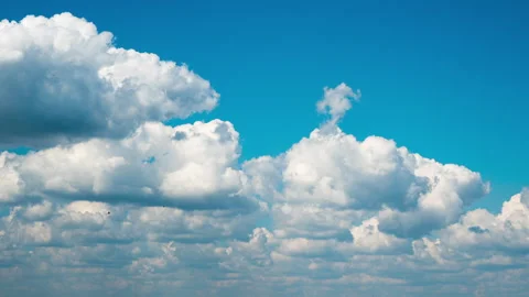 White Fluffy Clouds Slowly Float Through the Blue Daytime Sky Timelapse Stock Footage 190407459