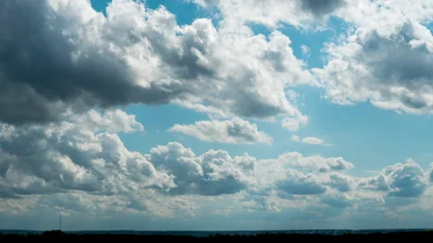 White Fluffy Clouds Slowly Float Through the Blue Daytime Sky Timelapse Stock Footage 193649977