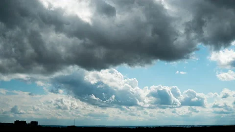 White Fluffy Clouds Slowly Float Through the Blue Daytime Sky Timelapse Stock Footage 194144584