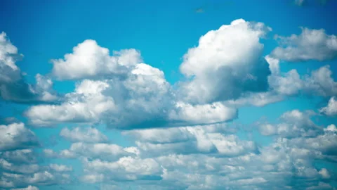 White Fluffy Clouds Slowly Float Through the Blue Daytime Sky Timelapse Stock Footage 194573299