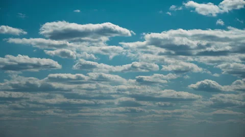 White Fluffy Clouds Slowly Float Through the Blue Daytime Sky Timelapse Stock Footage 194682801
