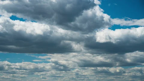 White Fluffy Clouds Slowly Float Through the Blue Daytime Sky Timelapse Stock Footage 197511224