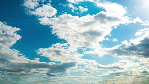 White Fluffy Clouds Slowly Float Through the Blue Daytime Sky Timelapse Video stock 197531928