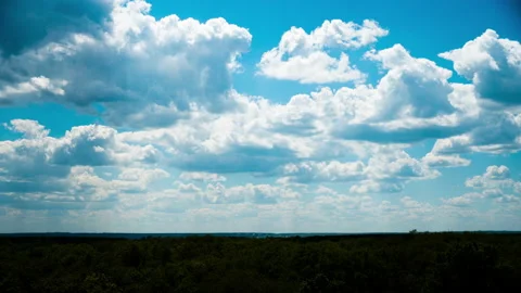 White Fluffy Clouds Slowly Float Through the Blue Daytime Sky Timelapse Stock Footage 197534469