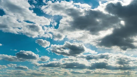 White Fluffy Clouds Slowly Float Through the Blue Daytime Sky Timelapse Stock Footage 197541159