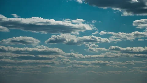 White Fluffy Clouds Slowly Float Through the Blue Daytime Sky Timelapse Stock Footage 197558929