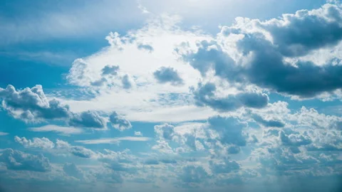 White Fluffy Clouds Slowly Float Through the Blue Daytime Sky Timelapse Stock Footage 197757938