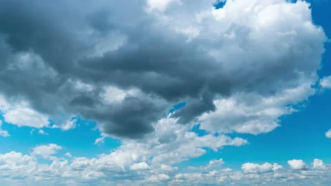 White Fluffy Clouds Slowly Float Through the Blue Daytime Sky Timelapse Stock Footage 200454752