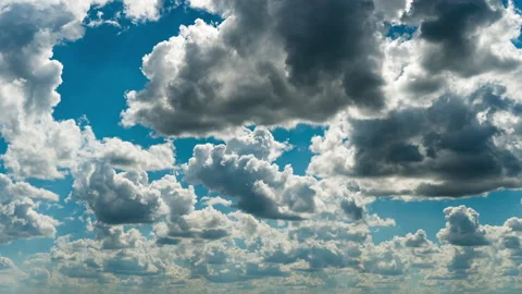 White Fluffy Clouds Slowly Float Through the Blue Daytime Sky Timelapse Stock Footage 201358090
