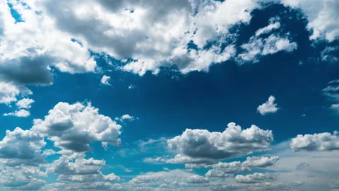 White Fluffy Clouds Slowly Float Through the Blue Daytime Sky Timelapse Stock Footage 201360094