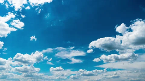 White Fluffy Clouds Slowly Float Through the Blue Daytime Sky Timelapse Stock Footage 201360576