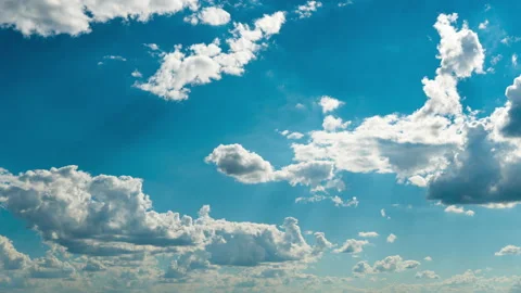 White Fluffy Clouds Slowly Float Through the Blue Daytime Sky Timelapse Video stock 201376559