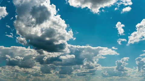 White Fluffy Clouds Slowly Float Through the Blue Daytime Sky Timelapse Stock Footage 201383353