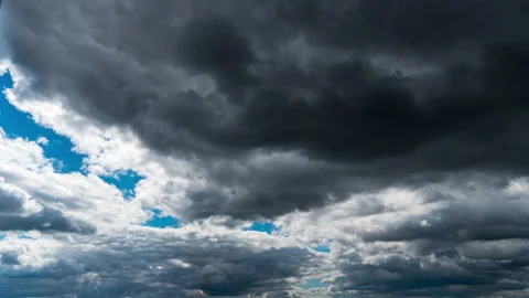 White Fluffy Clouds Slowly Float Through the Blue Daytime Sky Timelapse Stock Footage 209388337
