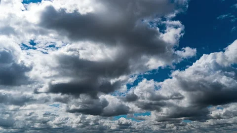 White Fluffy Clouds Slowly Float Through the Blue Daytime Sky Timelapse Stock Footage 211478826