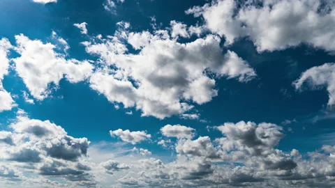 White Fluffy Clouds Slowly Float Through the Blue Daytime Sky Timelapse Stock Footage 212208193