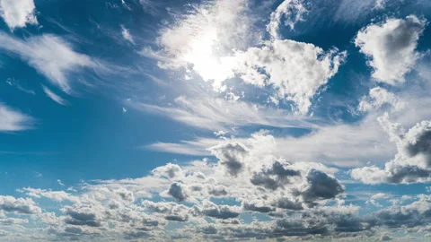 White Fluffy Clouds Slowly Float Through the Blue Daytime Sky Timelapse Stock Footage 213388167