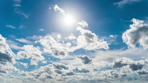 White Fluffy Clouds Slowly Float Through the Blue Daytime Sky Timelapse Stock Footage 213537540
