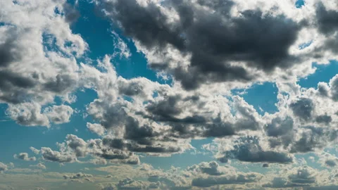 White Fluffy Clouds Slowly Float Through the Blue Daytime Sky Timelapse Stock Footage 214082291
