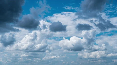 White Fluffy Clouds Slowly Float Through the Blue Daytime Sky Timelapse Stock Footage 214501950