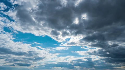 White Fluffy Clouds Slowly Float Through the Blue Daytime Sky Timelapse Stock Footage 214545645