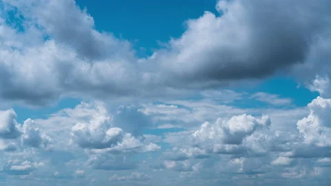 White Fluffy Clouds Slowly Float Through the Blue Daytime Sky Timelapse Stock Footage 214840151